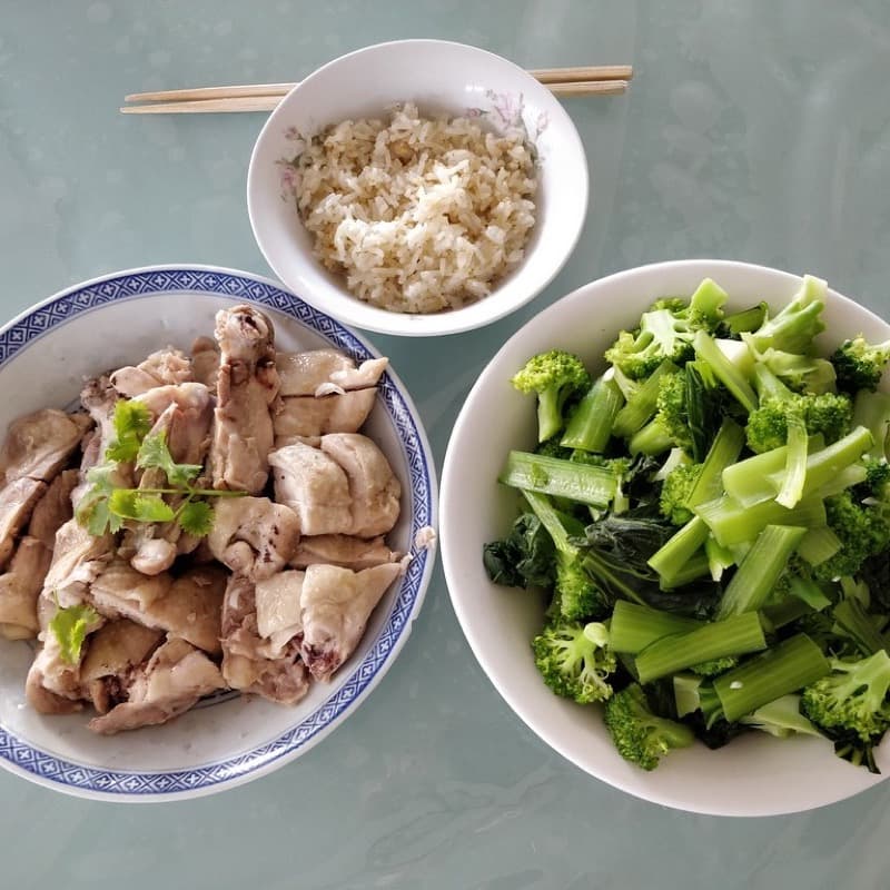 A photographed plate of grilled chicken, rice and broccoli